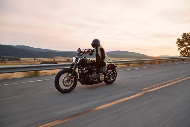 Motorcyclist wearing a helmet riding safely on a highway